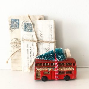 Charmingly shabby vintage toy bus with bottle brush tree